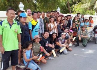 Happy volunteer wall painters gather for a group photo.