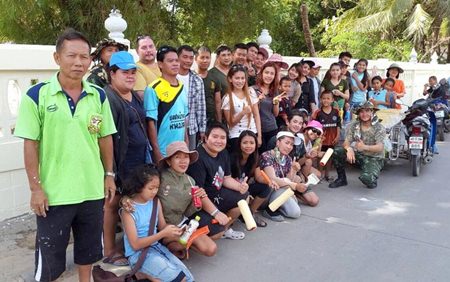 Happy volunteer wall painters gather for a group photo.