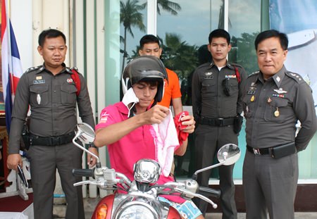 Police try to keep a straight face as Jetphinit Nonsriratch shows the press the pairs of women’s knickers he carried with him.
