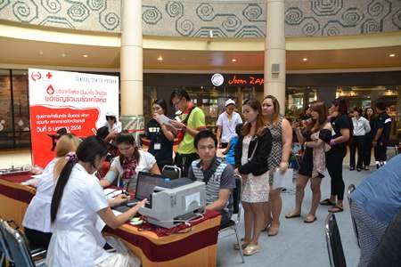 Residents and staff of Big C North Pattaya wait in line to take a blood test before donating to help people in need.
