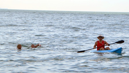 Chris on kayak accompanies the ladies during their swim to keep them safe.