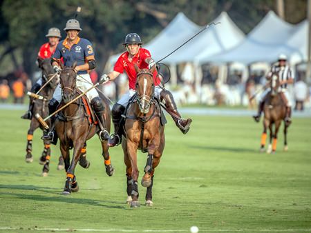 Thai Polo and Fast Fish riders chase the ball downfield in the Thai Polo Open final, Saturday, Jan. 17.