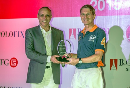 Harald Link (right) receives the International Southeast Asian Polo team award on behalf of Thai Polo Club from Dato Mohamed Moiz.