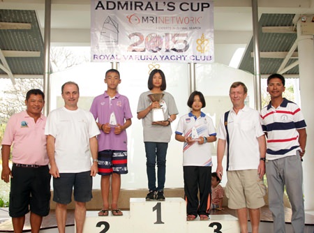 13-year old Intira Parnpiboon stands atop the podium with the Admiral’s Cup flanked by Chanakchon Wangsuk and Suchakree Detthoappol, who came 2nd and 3rd respectively in the Optimist division.  Also in picture are Mark Hamil-Stewart, Vice Commodore (2nd left), Chris Dando, Rear Commodore (2nd right) and Nattawut Vongrak - Kru Oat, Opti Coach from RVYC (far right), along with Kru Somkiat Poonpat, Thailand National Opti Coach (far left)