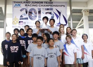 Junior sailors from Bangkok Prep. School stand atop the podium with the trophy as the teams from Bangkok Patana School (left) and Lycée Français (right) look on.