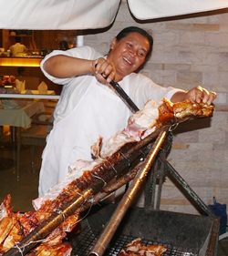 Thai Garden Resort chef merrily cutting away at the roast pig.