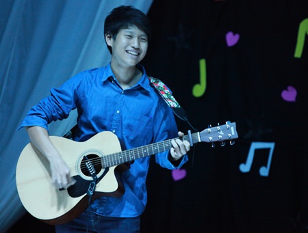 A Year 11 student plays guitar during the talent show.