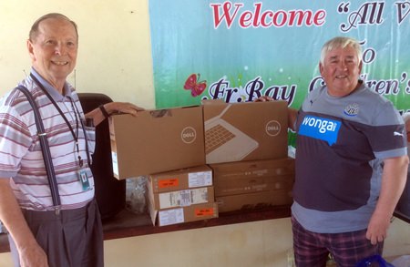 Robert Younger, right, presents his gifts to Brother Denis.