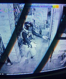 This still image taken from the security video camera allegedly shows Ayder Bezaziyev holding up the currency exchange shop.
