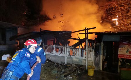 Firefighters attempt to extinguish the blaze, but were not in time to save the disabled woman trapped inside.