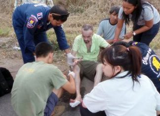 Russian hurt by hit-and-run driver in Sattahip EMTs render assistance to the injured Russian accident victim.