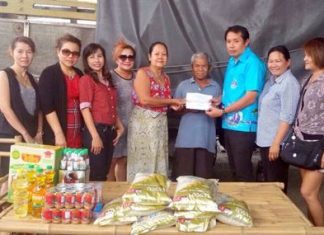 Patsakorn Yusomboon and members of the Soi Chaiyapornvitee committee help Jaroon and Salee Sadajai, two elderly grandparents that have fallen upon hardship.