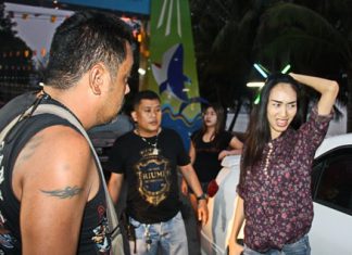 Suchada Inthuwong looks on in embarrassment as off duty narcotics police search her car and quiz her about illegal drug use.