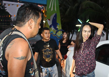 Suchada Inthuwong looks on in embarrassment as off duty narcotics police search her car and quiz her about illegal drug use.