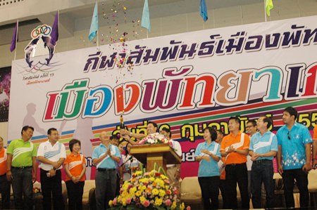 City officials cheer as Mayor Itthiphol Kunplome uncorks the ceremonial Champagne bottle to begin the party.