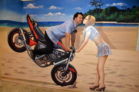 Mayor Itthiphol Kunplome poses for a photo with one of the interactive paintings.