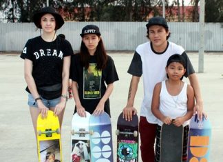 Surasak Takna (2nd right), president of the Khanong skateboard group, poses with fellow skateboard enthusiasts during the promotional display at Pattaya’s JJ Market on Jan. 31.