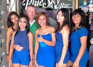 Kit (3rd left) celebrates his win with the staff at Blue Sky Bar.