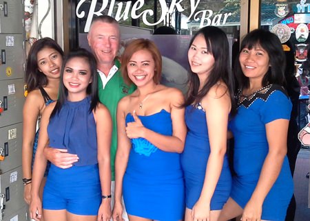 Kit (3rd left) celebrates his win with the staff at Blue Sky Bar.