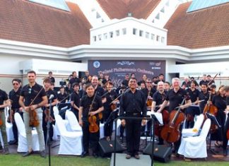 Conductor Lt. Col. Prateep Suphanrojn (centre) poses with the Thailand Philharmonic Orchestra at the Phornprapha Botanic Gardens in Pattaya.