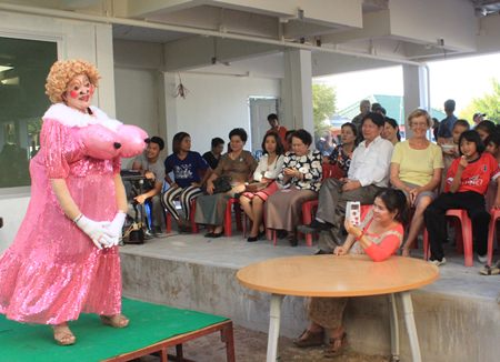 A volunteer from the Pattaya Career Foundation provides laughter with a comedy mime performance.