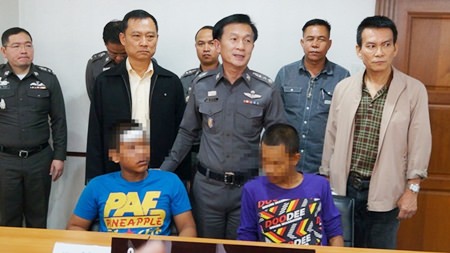 Two of the four accused rapists are brought out for the press.