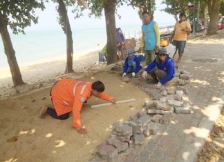 City workers filled in a 10-meter-long hole and built a cement retaining wall to prevent erosion, then laid bricks to complete the path at Yim Yom Beach.