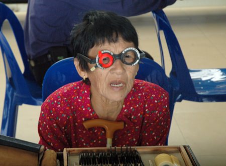 Riam Saengo, 89, has an eye exam because she cannot see her TV programs clearly.