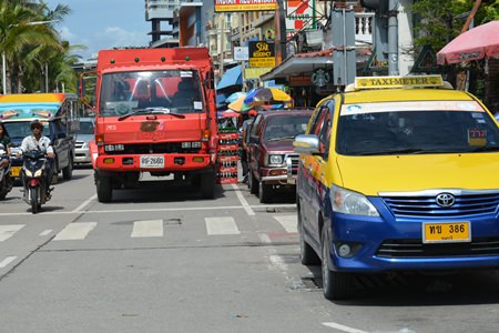 A coke truck double-parked at the northern end of Beach Road blocks traffic.