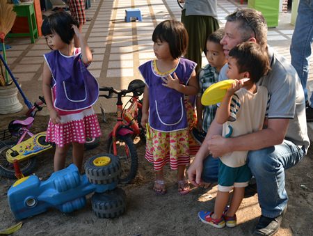 Paul Strachan, one of the organisers of the beach BBQ, spends a few moments giving love and care to the children at the home.