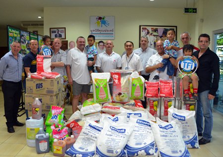 TFi are joined by sponsors and Derek Franklin and Father Peter for the donation of goods.
