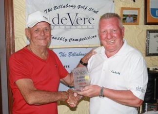 Robbie Taylor (left) receives the deVere trophy from Brian Chapman.