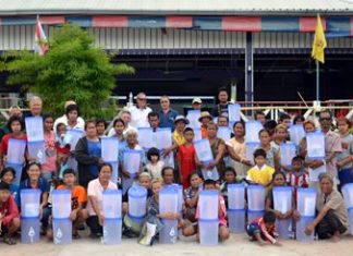Members of TFi and the Rotary Club Of Eastern Seaboard present portable water filters to some of the most impoverished members of the local community.