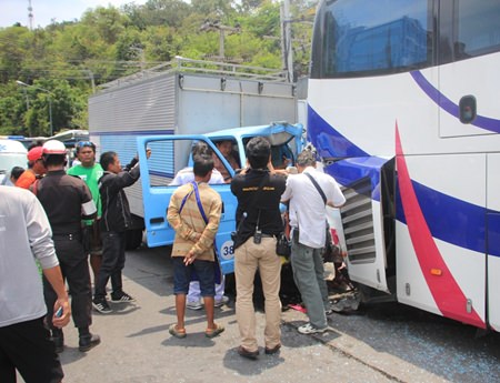 Surat Thai-oun and passenger Worachai Sripanoun were pinned in their truck when it slammed into the back of a tour bus.