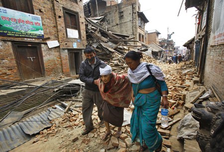 An elderly injured woman is taken to her home after treatment in Bhaktapur near Kathmandu, Nepal, Sunday, April 26. A strong magnitude 7.8 earthquake shook Nepal’s capital and the densely populated Kathmandu Valley before noon Saturday, April 25, causing extensive damage with toppled walls and collapsed buildings, officials said. (AP Photo/Niranjan Shrestha)