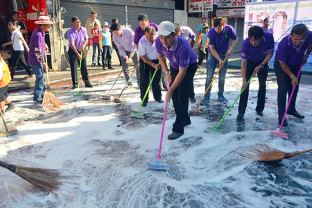 Mayor Itthiphol Kunplome leads local leaders and city workers in scrubbing down Walking Street.