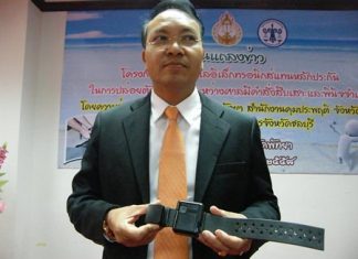 Chief Justice Apichart Thepnoo presents one of the GPS tracking bracelets.