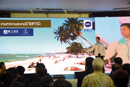 Pattaya Mayor Itthiphol Kunplome uses a large screen video to address 500 community leaders, residents and officials about his administration’s achievements.
