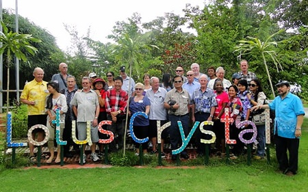 PCEC members and guests on a day trip pose in front of the sign for the glass factory they visited on their way to Rayong’s famous Fruit Farm.
