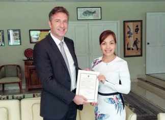 HE Ambassador Enno Drofenik presents Sriwanna Jitprasert with her certificate of appointment.