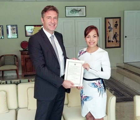 HE Ambassador Enno Drofenik presents Sriwanna Jitprasert with her certificate of appointment.