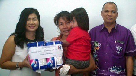 PSC Charity Chairwoman Noi Emmerson (left) leads the handover of 50,000 baht to Nongprue Sub-district for milk, eggs, diapers and other staples for families with special-needs children.