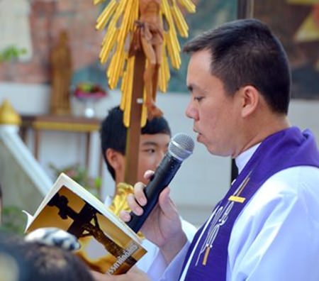 Pastor Francis Xavier Sukkaphat leads the parade on Good Friday.