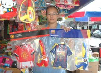 Nongrak shows some of her water guns for youngsters. She has been taking orders from football lovers for particular football teams.