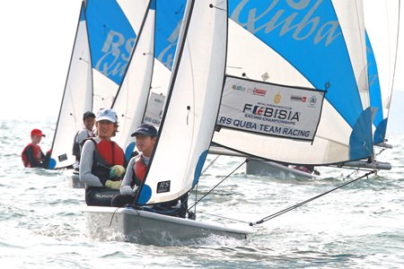 Sailors tack to the start line during the team racing event.
