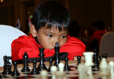 A potential budding Grandmaster ponders his next move.