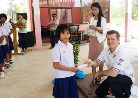 Dr. Ramin Yachkaschi presents one little girl with her scholarship.
