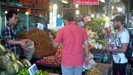 Tourists buy fruit at the market in front of Wat Chaimongkol. Durian (front, lower left) especially becomes popular during the hot season.