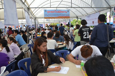 Job hunters fill out applications and prepare for interviews with prospective employers during the recent job fair at Pattaya City Hall.
