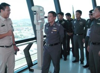 Royal Thai Police Deputy Commissioner-General Pol. Gen. Wuthi Liptapanlop (center) inspects surveillance equipment on top of a 20-story tower overlooking the entire port area.